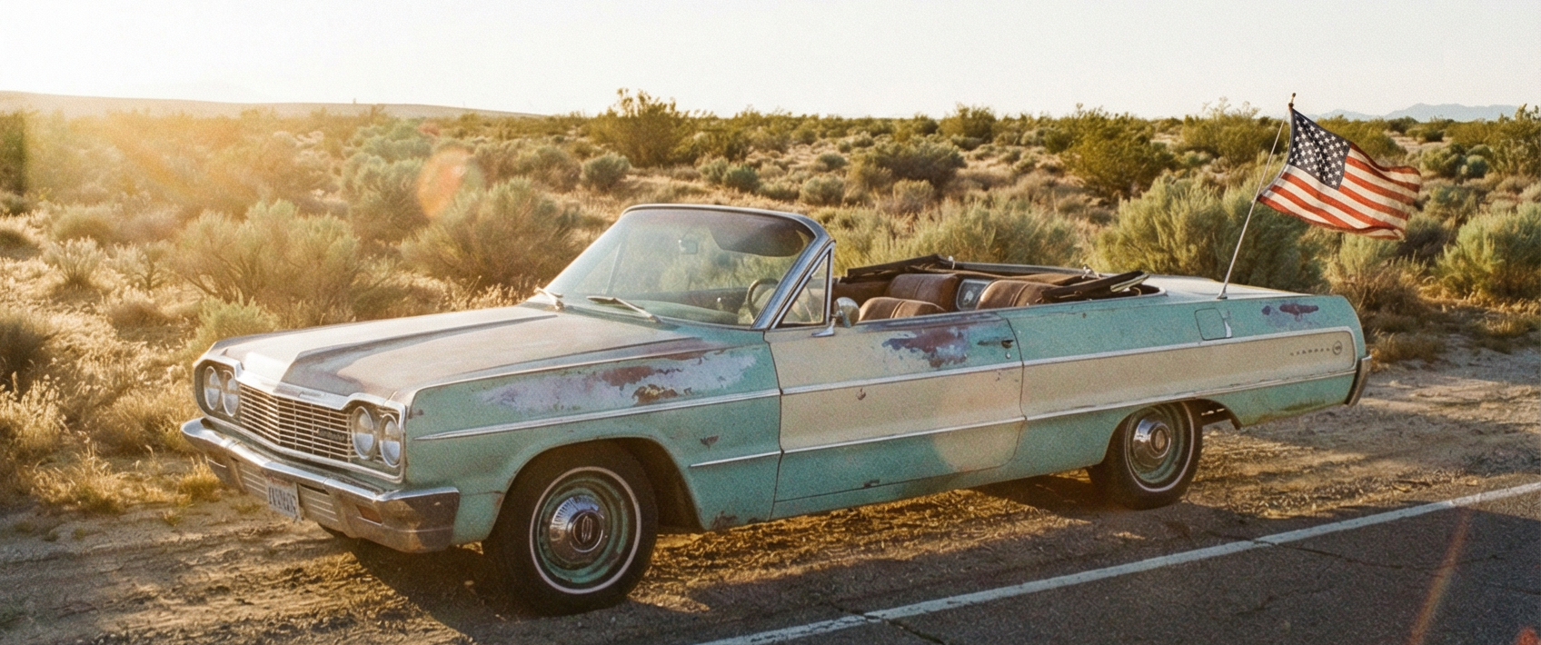 Vintage car with American flag on a desert road